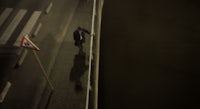 a man walking down a street at night
